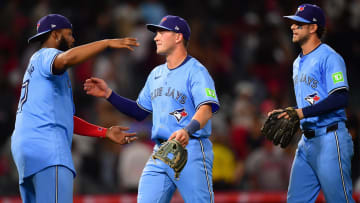 Aug 12, 2024; Anaheim, California, USA; Toronto Blue Jays designated hitter Vladimir Guerrero Jr. (27) second baseman Will Wagner (7) and left fielder Joey Loperfido (9) celebrate the victory against the Los Angeles Angels at Angel Stadium. Mandatory Credit: Gary A. Vasquez-USA TODAY Sports