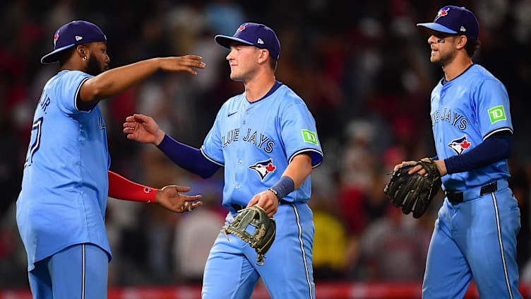 Aug 12, 2024; Anaheim, California, USA; Toronto Blue Jays designated hitter Vladimir Guerrero Jr. (27) second baseman Will Wagner (7) and left fielder Joey Loperfido (9) celebrate the victory against the Los Angeles Angels at Angel Stadium. Mandatory Credit: Gary A. Vasquez-USA TODAY Sports