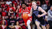 BYU Cougars guard Richie Saunders (15) dribbles the ball while Arizona Wildcats guard KJ Lewis (5) follows him during the first half at McKale Center.