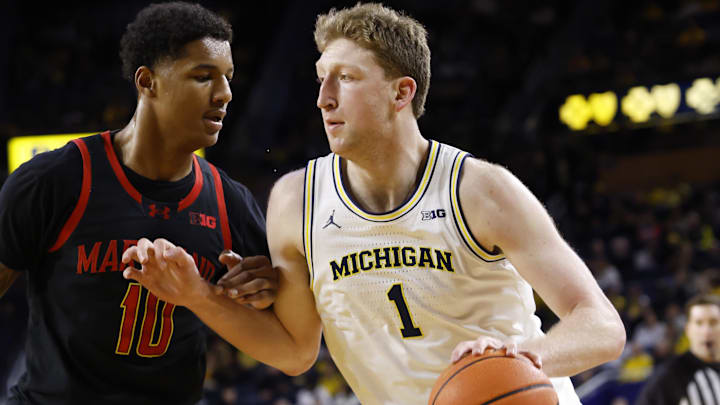 Mar 5, 2025; Ann Arbor, Michigan, USA;  Michigan Wolverines center Danny Wolf (1) is defended by Maryland Terrapins forward Julian Reese (10) in the first half at Crisler Center. Mandatory Credit: Rick Osentoski-Imagn Images