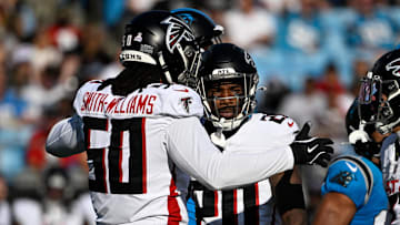 Oct 13, 2024; Charlotte, North Carolina, USA;  Atlanta Falcons defensive end James Smith-Williams (50) reacts with cornerback Dee Alford (20) in the first quarter at Bank of America Stadium.