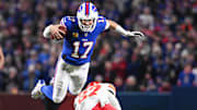 Josh Allen leaps over Chiefs safety Chamarri Conner to get a first down.