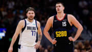 Dallas Mavericks guard Luka Doncic (77) and Denver Nuggets center Nikola Jokic.