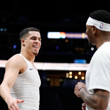 Denver Nuggets forward Michael Porter Jr. (1) talks with Phoenix Suns forward Torrey Craig (0) before the game at Ball Arena. 