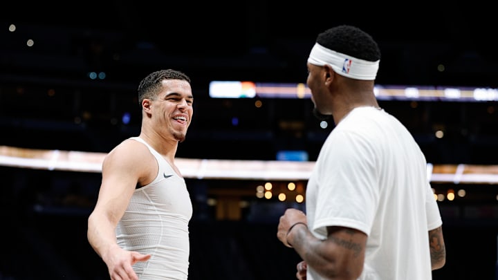 Denver Nuggets forward Michael Porter Jr. (1) talks with Phoenix Suns forward Torrey Craig (0) before the game at Ball Arena. 