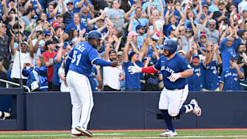 Sep 28, 2025; Toronto, Ontario, CAN;  Toronto Blue Jays catcher Alejandro Kirk (30) is congratulated by third base coach Carlos Febles (51) after hitting a two-run home run against the Tampa Bay Rays in the fifth inning at Rogers Centre. Mandatory Credit: Dan Hamilton-Imagn Images