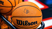 A basketball emblazoned with the Louisville logo