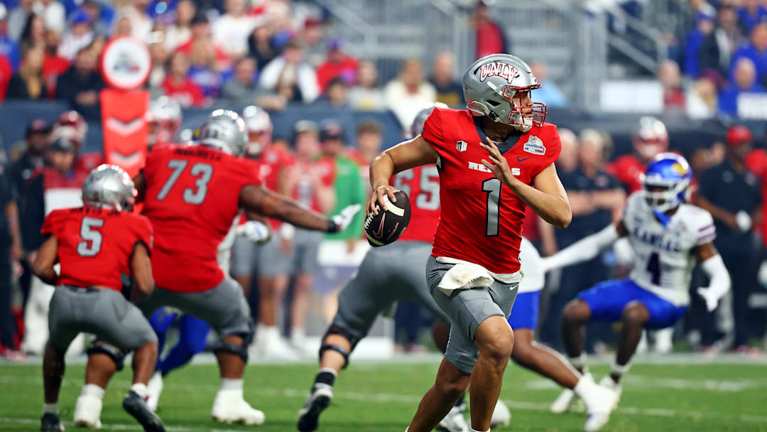 Dec 26, 2023; Phoenix, AZ, USA; UNLV Rebels quarterback Jayden Maiava (1) rolls out to pass during the second half against the Kansas Jayhawks in the Guaranteed Rate Bowl at Chase Field. Mandatory Credit: Mark J. Rebilas-Imagn Images Dec 26, 2023; Phoenix, AZ, USA; UNLV Rebels quarterback Jayden Maiava (1) rolls out to pass during the second half against the Kansas Jayhawks in the Guaranteed Rate Bowl at Chase Field. Mandatory Credit: Mark J. Rebilas-Imagn Images