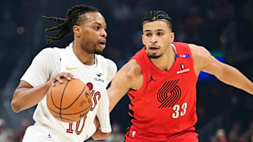 Mar 2, 2025; Cleveland, Ohio, USA; Cleveland Cavaliers guard Darius Garland (10) drives to the basket against Portland Trail Blazers forward Toumani Camara (33) during the first half at Rocket Arena. Mandatory Credit: Ken Blaze-Imagn Images