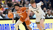 Texas Longhorns guard Jordan Pope (0) drives up court past Vanderbilt Commodores guard Tyler Nickel (5) during the first half at Bridgestone Arena in Nashville, Tenn., Wednesday, March 12, 2025.