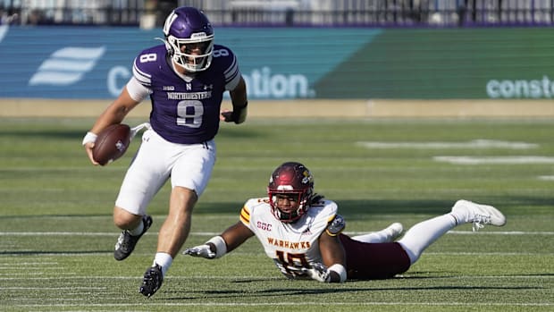 Northwestern Wildcats quarterback Preston Stone runs the ball past ULM Warhawks defensive back Zy Jackson.