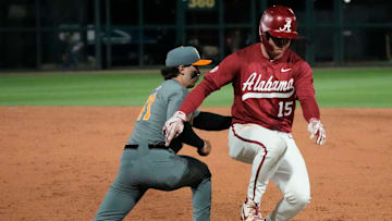 Mar 20, 2025; Tuscaloosa AL, USA; Alabama outfielder Coleman Mizell (15) barely gets back safely as Tennessee infielder Andrew Fischer (11) takes a pickoff throw from Tennessee pitcher Liam Doyle (12) at Sewell-Thomas Stadium.
