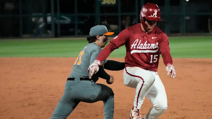 Mar 20, 2025; Tuscaloosa AL, USA; Alabama outfielder Coleman Mizell (15) barely gets back safely as Tennessee infielder Andrew Fischer (11) takes a pickoff throw from Tennessee pitcher Liam Doyle (12) at Sewell-Thomas Stadium.