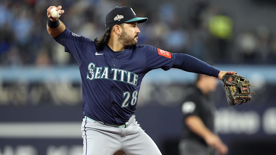 Oct 20, 2025; Toronto, Ontario, CAN; Seattle Mariners third baseman Eugenio Suarez (28) throws out Toronto Blue Jays right fielder George Springer (4) at first base in the second inning during game seven of the ALCS round for the 2025 MLB playoffs at Rogers Centre. 