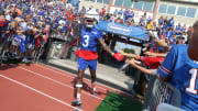 Bills defensive back Damar Hamlin high-fives fans as he runs onto the field during the opening day of Buffalo Bills training camp at St. John Fisher University.