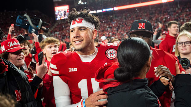 Nov 23, 2024; Lincoln, Nebraska, USA; Nebraska Cornhuskers quarterback Dylan Raiola (15) walks off as fans rush the field aft