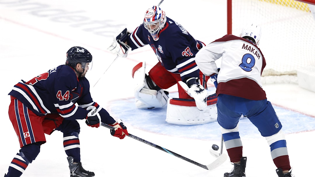 Mar 14, 2026; Winnipeg, Manitoba, CAN; Winnipeg Jets defenseman Josh Morrissey (44) stick checks Colorado Avalanche defenseman Cale Makar (8) in front of Winnipeg Jets goaltender Connor Hellebuyck (37) in the first period at Canada Life Centre. Mandatory Credit: James Carey Lauder-Imagn Images Mar 14, 2026; Winnipeg, Manitoba, CAN; Winnipeg Jets defenseman Josh Morrissey (44) stick checks Colorado Avalanche defenseman Cale Makar (8) in front of Winnipeg Jets goaltender Connor Hellebuyck (37) in the first period at Canada Life Centre. Mandatory Credit: James Carey Lauder-Imagn Images