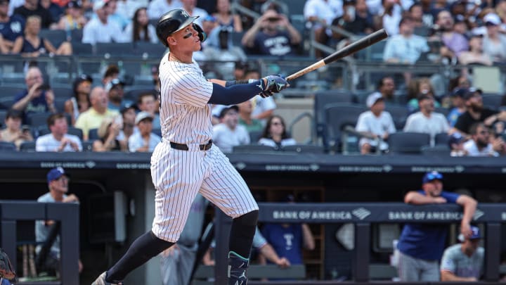 Aug 11, 2024; Bronx, New York, USA; New York Yankees center fielder Aaron Judge (99) hits a solo home run during the seventh inning against the Texas Rangers at Yankee Stadium. Mandatory Credit: Vincent Carchietta-USA TODAY Sports