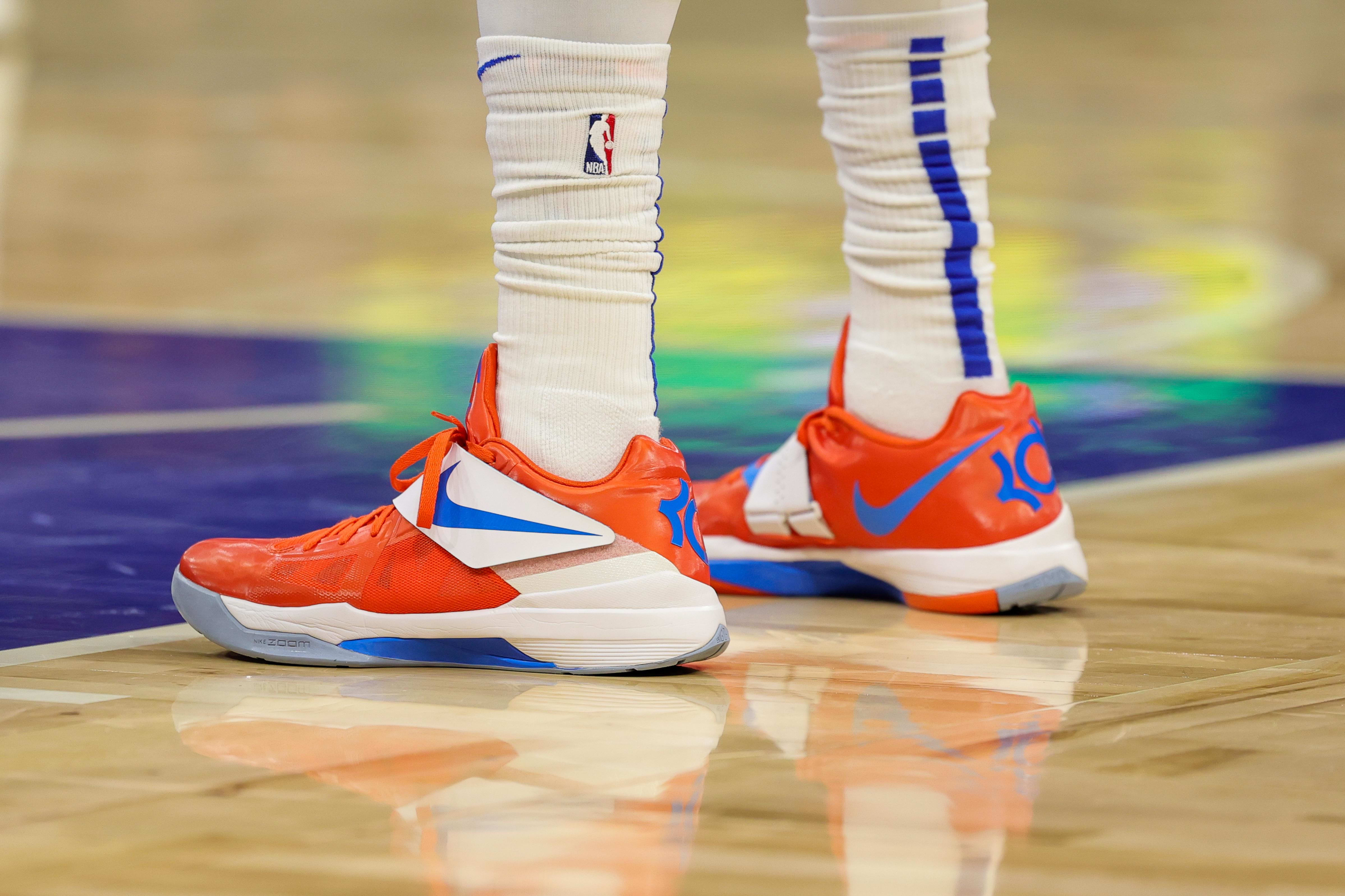 Orlando Magic guard Markelle Fultz' orange and blue Nike sneakers.