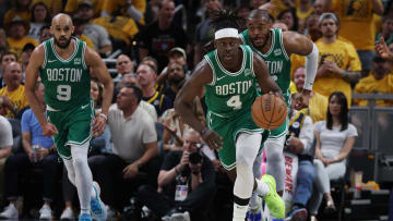 May 25, 2024; Indianapolis, Indiana, USA; Boston Celtics guard Jrue Holiday (4) brings the bal up court with guard Derrick White (9) and forward Xavier Tillman (26) against the Indiana Pacers during the third quarter of game three of the eastern conference finals in the 2024 NBA playoffs at Gainbridge Fieldhouse. Mandatory Credit: Trevor Ruszkowski-USA TODAY Sports