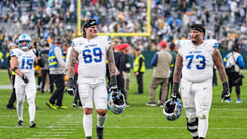 Detroit Lions guards Tate Ratledge (69) and Christian Mahogany (73) walk off the field after the 27-13 loss to the Green Bay Packers at Lambeau Field in Green Bay, Wis., on Sunday, September 7, 2025.