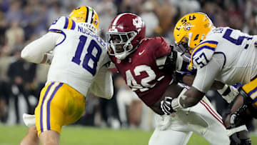 Nov 8, 2025; Tuscaloosa, Alabama, USA;  Alabama linebacker Yhonzae Pierre (42) fights off a block by LSU offensive lineman Carius Curne (57) to sack LSU quarterback Garrett Nussmeier (18) for a loss at Saban Field at Bryant-Denny Stadium. Alabama defeated LSU 20-9. Mandatory Credit: Gary Cosby Jr.-Imagn Images