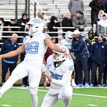 Nov 23, 2024; Chestnut Hill, Massachusetts, USA;  North Carolina Tar Heels place kicker Noah Burnette (98) kicks an extra point against the Boston College Eagles during the second half at Alumni Stadium. 