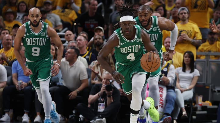 May 25, 2024; Indianapolis, Indiana, USA; Boston Celtics guard Jrue Holiday (4) brings the bal up court with guard Derrick White (9) and forward Xavier Tillman (26) against the Indiana Pacers during the third quarter of game three of the eastern conference finals in the 2024 NBA playoffs at Gainbridge Fieldhouse. Mandatory Credit: Trevor Ruszkowski-USA TODAY Sports