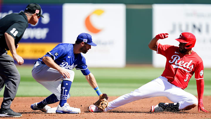 Los Angeles Dodgers second baseman Chris Taylor (3) tags out Cincinnati Reds first baseman Jeimer Candelario (3) in the second inning of a Cactus League game between the Cincinnati Reds and Los Angeles Dodgers, Monday, Feb. 24, 2025, at Goodyear Ballpark in Goodyear, Ariz. Los Angeles Dodgers second baseman Chris Taylor (3) tags out Cincinnati Reds first baseman Jeimer Candelario (3) in the second inning of a Cactus League game between the Cincinnati Reds and Los Angeles Dodgers, Monday, Feb. 24, 2025, at Goodyear Ballpark in Goodyear, Ariz.