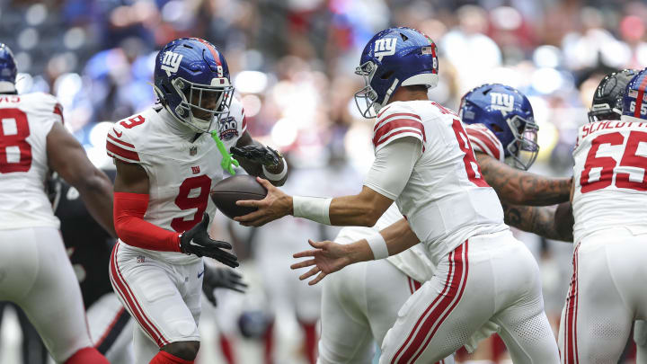 Aug 17, 2024; Houston, Texas, USA; New York Giants quarterback Daniel Jones (8) hands off the ball to wide receiver Malik Nabers (9) during the game against the Houston Texans at NRG Stadium.  