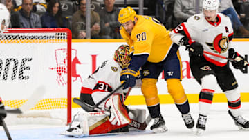Feb 3, 2025; Nashville, Tennessee, USA; Ottawa Senators goaltender Anton Forsberg (31) blocks the puck as Nashville Predators center Ryan O'Reilly (90) gets in his way during the second period at Bridgestone Arena. Mandatory Credit: Steve Roberts-Imagn Images