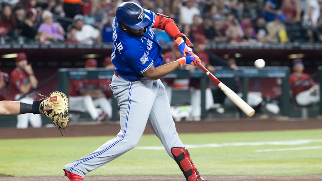 Apr 19, 2026; Phoenix, Arizona, USA; Toronto Blue Jays first baseman Vladimir Guerrero Jr. hits a two-run single in the first inning against the Arizona Diamondbacks at Chase Field. Mandatory Credit: Mark J. Rebilas-Imagn Images