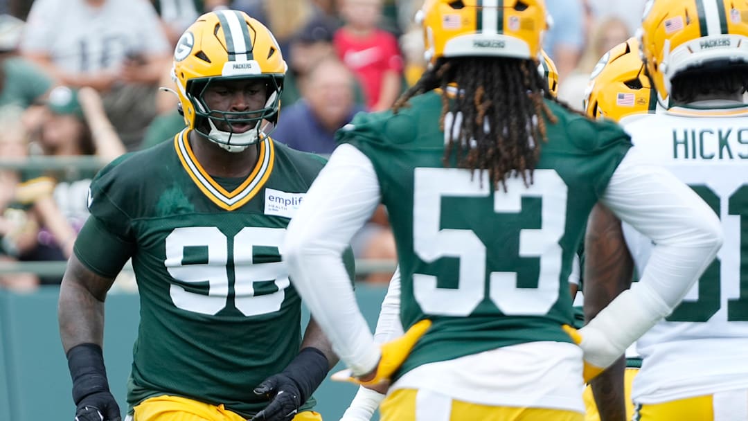 Green Bay Packers defensive tackle Colby Wooden (96) and defensive end Arron Mosby (53) run through a drill during the second day of training camp on Thursday, July 24, 2025, at Ray Nitschke Field in Ashwaubenon, Wis.