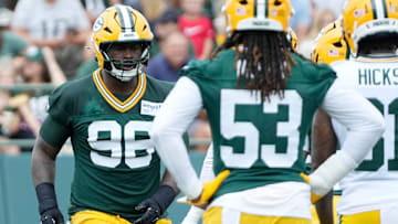 Green Bay Packers defensive tackle Colby Wooden (96) and defensive end Arron Mosby (53) run through a drill during the second day of training camp on Thursday, July 24, 2025, at Ray Nitschke Field in Ashwaubenon, Wis.
