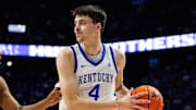 Nov 4, 2025; Lexington, Kentucky, USA; Kentucky Wildcats forward Andrija Jelavic (4) handles the ball against Nicholls Colonels forward Sincere Malone (5) during the second half at Rupp Arena at Central Bank Center. Mandatory Credit: Jordan Prather-Imagn Images