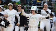 Oregon’s Paige Sinicki, center, celebrates scoring a run off an Emma Cox home run during the third inning.