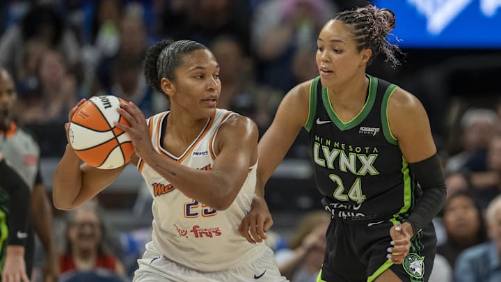 Sep 21, 2025; Minneapolis, Minnesota, USA; Phoenix Mercury forward Alyssa Thomas (25) holds the ball as Minnesota Lynx forward Napheesa Collier (24) plays defense in the first half during game one of the second round for the 2025 WNBA Playoffs at Target Center. Mandatory Credit: Jesse Johnson-Imagn Images Sep 21, 2025; Minneapolis, Minnesota, USA; Phoenix Mercury forward Alyssa Thomas (25) holds the ball as Minnesota Lynx forward Napheesa Collier (24) plays defense in the first half during game one of the second round for the 2025 WNBA Playoffs at Target Center. Mandatory Credit: Jesse Johnson-Imagn Images