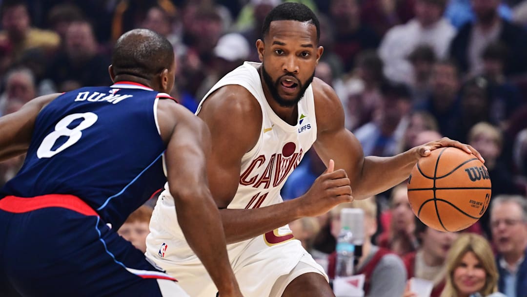 Mar 30, 2025; Cleveland, Ohio, USA; Cleveland Cavaliers forward Evan Mobley (4) drives to the basket against Los Angeles Clippers guard Kris Dunn (8) during the first quarter at Rocket Arena. Mandatory Credit: Ken Blaze-Imagn Images
