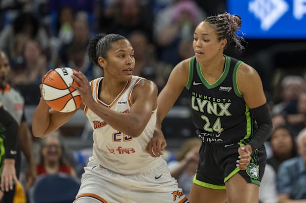 Phoenix Mercury forward Alyssa Thomas (25) holds the ball as Minnesota Lynx forward Napheesa Collier