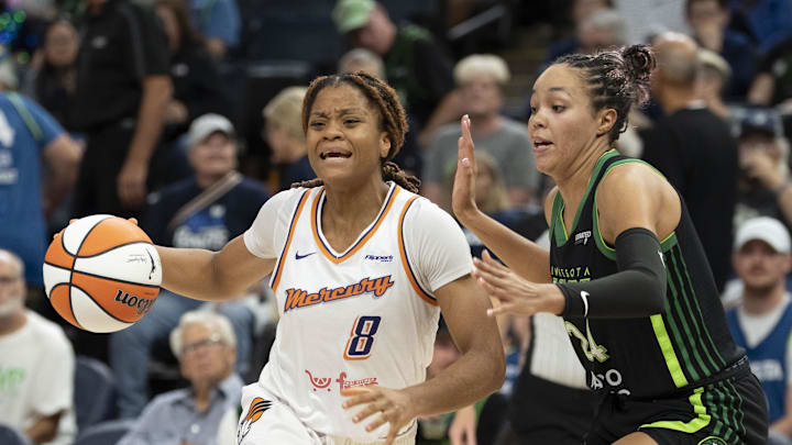 Sep 23, 2025; Minneapolis, Minnesota, USA; Phoenix Mercury guard Monique Akoa Makani (8) dribbles past Minnesota Lynx forward Napheesa Collier (24) in the second half during game two of the second round for the 2025 WNBA Playoffs at Target Center. Mandatory Credit: Jesse Johnson-Imagn Images