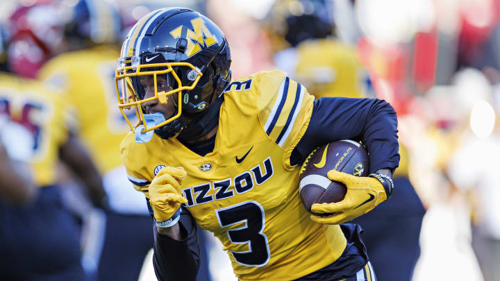 Luther Burden III #3 of the Missouri Tigers runs the ball during the game against the Arkansas Razorbacks at Donald W. Reynolds Razorback Stadium on November 24, 2023 in Fayetteville, Arkansas. The Tigers defeated the Razorbacks 48-14.