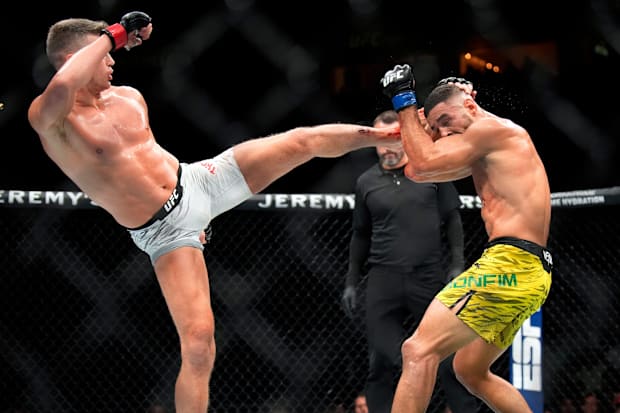 Stephen Thompson, left, kicks Gabriel Bonfim during a UFC Fight Night welterweight fight at Bridgestone Arena.