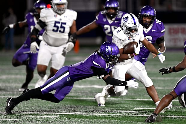 Tarleton State cornerback Kasyus Kurns tackles Abilene Christian running back Sam Hicks.