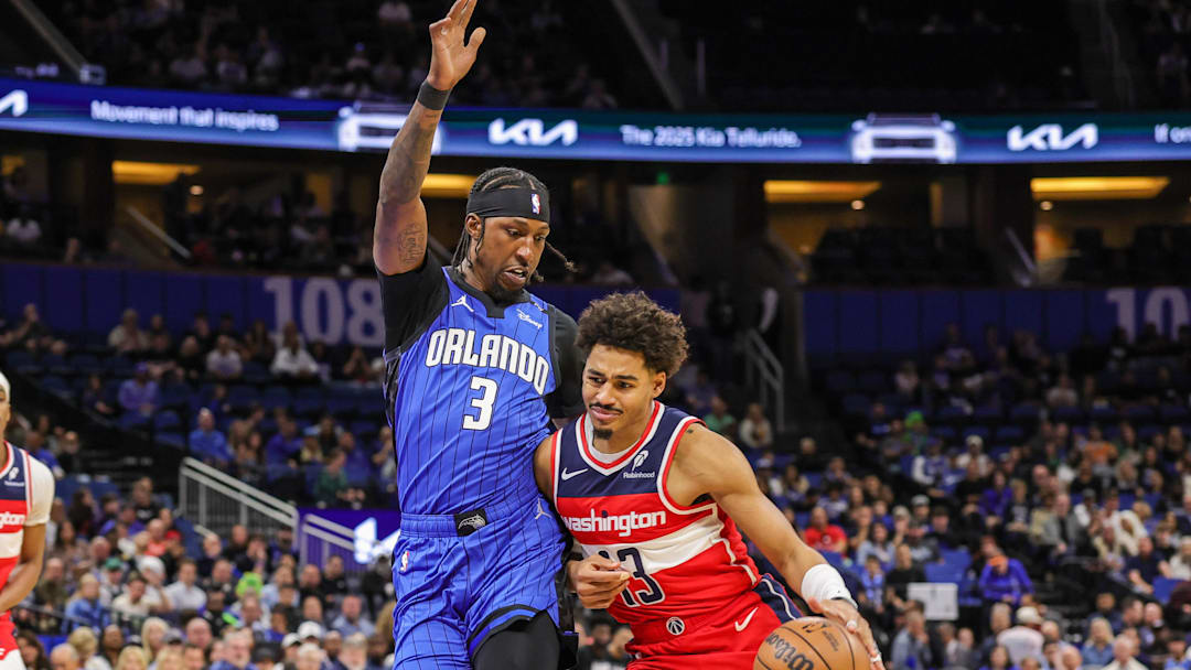 Feb 23, 2025; Orlando, Florida, USA; Washington Wizards guard Jordan Poole (13) drives past Orlando Magic guard Kentavious Caldwell-Pope (3) during the first quarter at Kia Center. Mandatory Credit: Mike Watters-Imagn Images