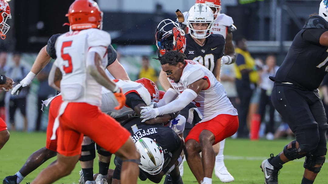 Sep 7, 2024; Orlando, Florida, USA; Sam Houston State Bearkats defensive back Caleb Weaver (3) loses his helmet while tackling UCF Knights quarterback KJ Jefferson (1) during the first quarter against the at FBC Mortgage Stadium. Mandatory Credit: Mike Watters-Imagn Images