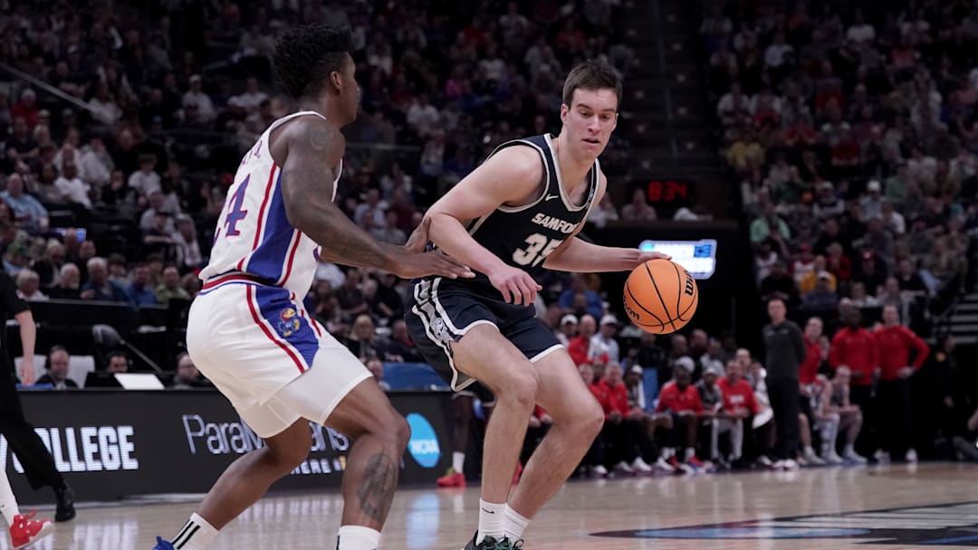Mar 21, 2024; Salt Lake City, UT, USA; Samford Bulldogs center Riley Allenspach (35) dribbles against Kansas Jayhawks forward K.J. Adams Jr. (24) during the first half in the first round of the 2024 NCAA Tournament at Vivint Smart Home Arena-Delta Center. Mandatory Credit: Gabriel Mayberry-Imagn Images