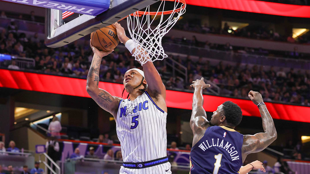 Jan 11, 2026; Orlando, Florida, USA; Orlando Magic forward Paolo Banchero (5) goes to the basket against New Orleans Pelicans forward Zion Williamson (1) during the second half at Kia Center. Mandatory Credit: Mike Watters-Imagn Images