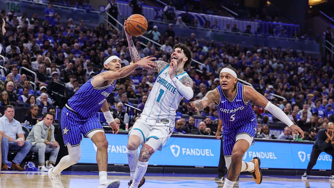 Apr 17, 2026; Orlando, Florida, USA; Charlotte Hornets guard LaMelo Ball (1) is fouled by Orlando Magic guard Anthony Black (0) during the second half during the play-in rounds of the 2026 NBA Playoffs at Kia Center. Mandatory Credit: Mike Watters-Imagn Images