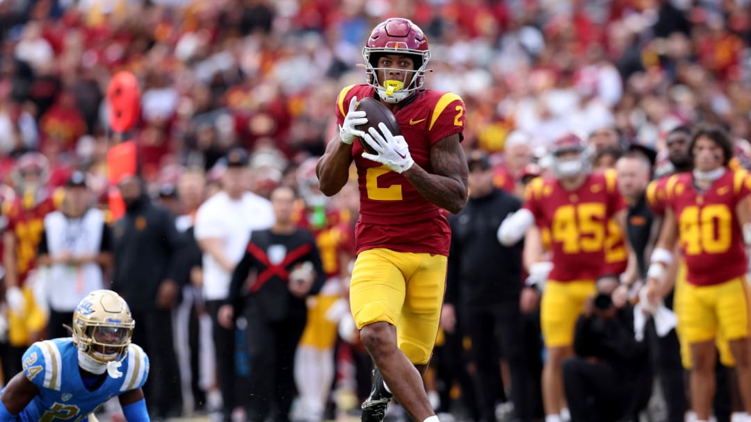 Nov 18, 2023; Los Angeles, California, USA; USC Trojans wide receiver Brenden Rice (2) catches a touchdown against UCLA Bruins defensive back Jaylin Davies (24) during the second quarter at United Airlines Field at Los Angeles Memorial Coliseum. Mandatory Credit: Jason Parkhurst-USA TODAY Sports