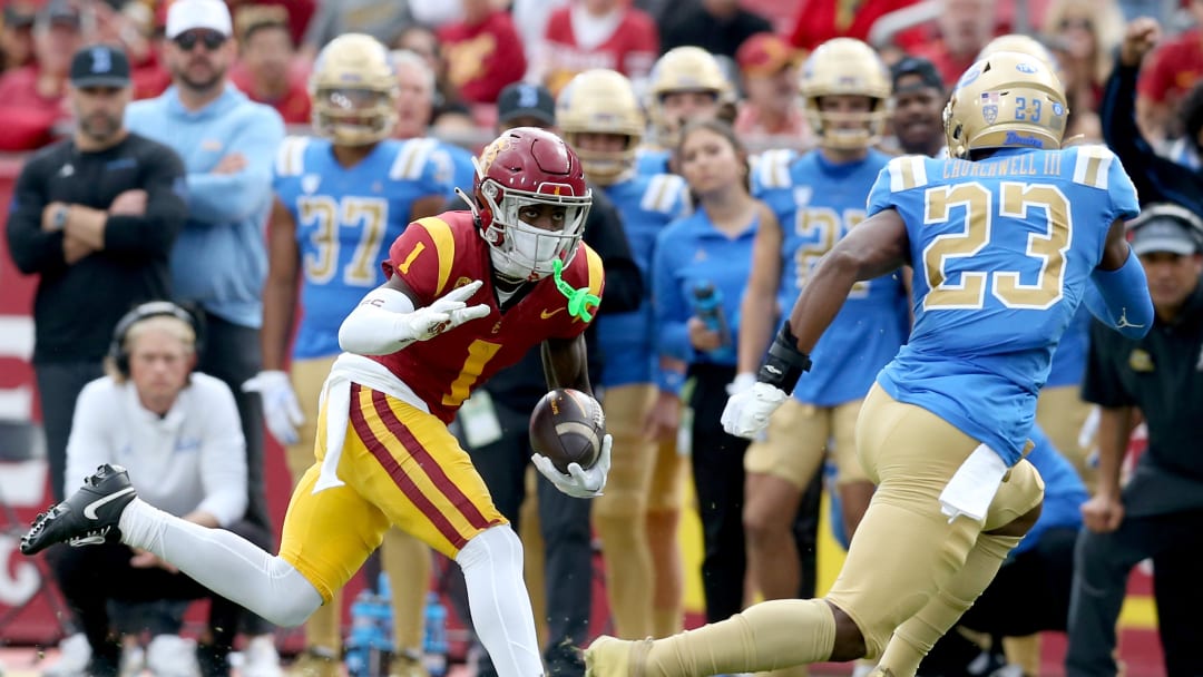 Nov 18, 2023; Los Angeles, California, USA; USC Trojans wide receiver Zachariah Branch (1) runs against UCLA Bruins defensive back Kenny Churchwell III (23) during the first quarter at United Airlines Field at Los Angeles Memorial Coliseum. Mandatory Credit: Jason Parkhurst-USA TODAY Sports